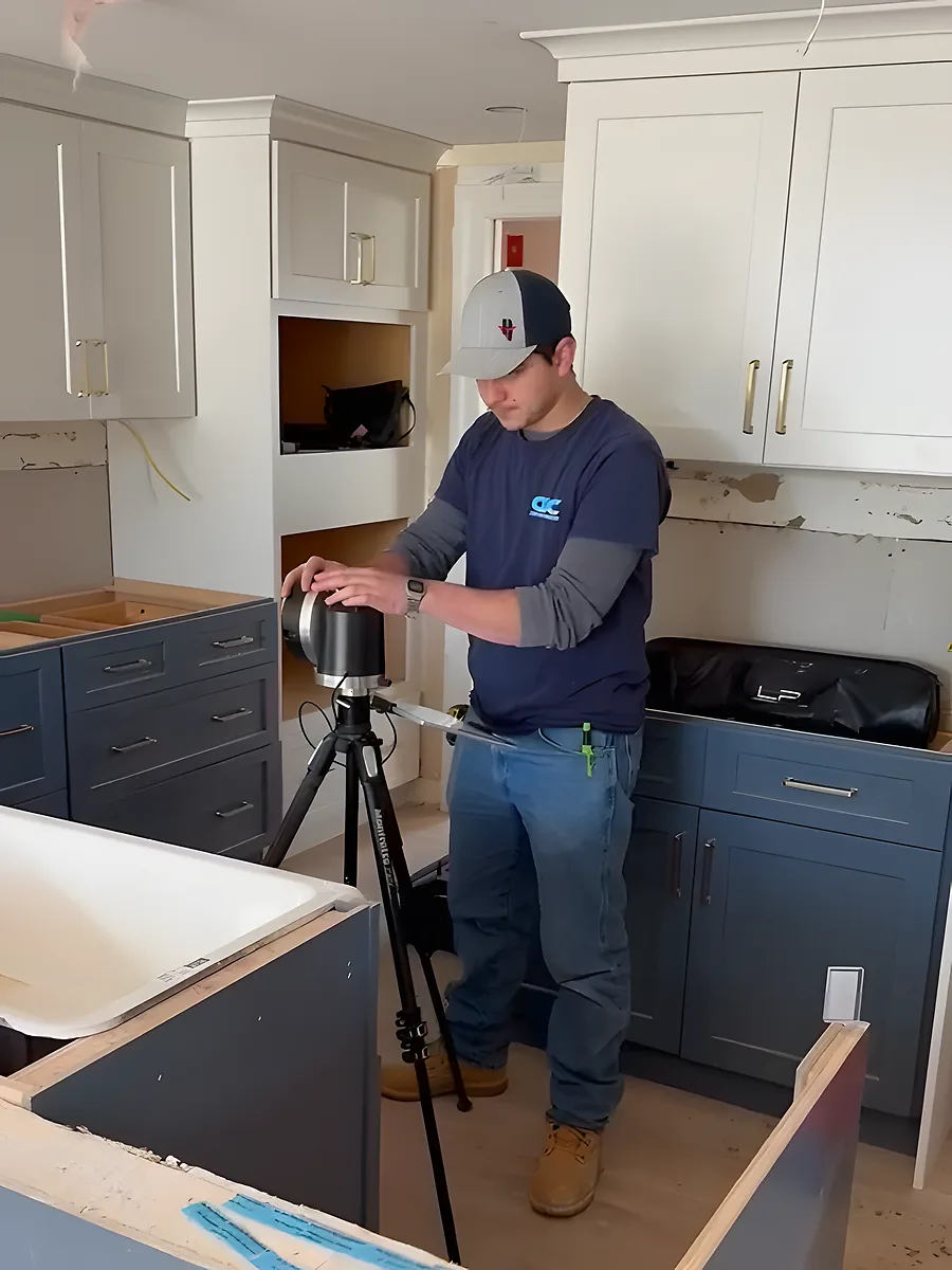Our templater on site with the laser templating system, shooting the points of the cabinets