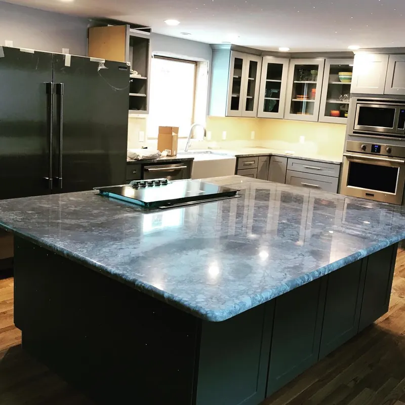 Super White island, 6 by 8 feet, with a cooktop on a dark base, Harwich, MA